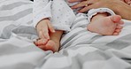 Baby feet, hands and mother on bed in home, playing and bonding. Affection, care and love of mama or parent with infant, child or kid, enjoying quality time together or caring for toddler in house.
