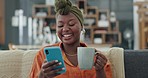 Coffee, phone and laughing black woman on sofa in house or home living room on dating app, comic internet news or funny meme. Smile, happy and relax person on social media mobile technology with tea