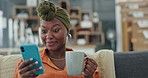 Happy black woman, smartphone and texting getting excited from cellphone news communication in a modern apartment home in Ghana. Woman, talking on phone and adult with coffee on sofa in house lounge 