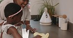 Cloth, mother and child cleaning the kitchen counter, helping and happy with housekeeping in a house. Housework, chores and African mom with a girl kid to help clean their dirty home for hygiene