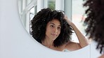 Black woman, natural hair and afro with reflection in bathroom mirror for beauty, hair care and getting ready at home. Model face during morning routine for self care with cosmetic and growth shampoo