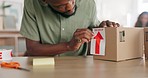 Ecommerce, logistics and small business, man with package for delivery of unique product in home office. Success, online retail startup, and businessman putting label on box for international export