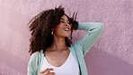Black woman play with afro, hair and is happy, peace and freedom with excited high energy. Young beauty, retro fashion and Brazil girl with curly hairstyle having fun and enjoy relax lifestyle
