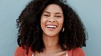 Happy, smile and laugh with the face and head of an attractive black woman smiling on a gray background or wall. Closeup portrait of a carefree and beautiful female with a positive attitude and afro