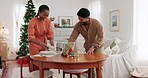 Christmas, black man and woman prepare table, happy and being loving together for holidays, being festive and bonding. Love, African American couple and celebrate with lunch, happiness and joyful.