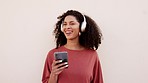 Music headphones, phone and dancing woman listening to audio on radio, streaming podcast and dance to mobile app against pink mockup studio background. Happy and excited African person with tech