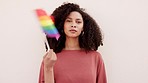 Pride, lgbtq and rainbow sign and flag of a woman serious and committed about support for gay rights. Portrait of a homosexual, lesbian and queer advocate and supporter person wave a freedom symbol