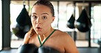 Boxing, sports and cardio with a woman fighter punching hitting or striking in a gym for self defense. Fitness, workout and training with a female boxer in a health club for exercise or a fight