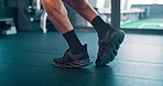 Skipping, rope and feet of a man training his balance with a cardio exercise in the gym. Fitness, sport and legs of an athlete jumping during a workout for energy, power and a body goal on the floor