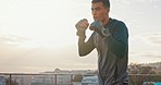 Man boxing outdoor, fitness and exercise with boxer and sports in urban city with health and wellness motivation. Strong, fast and sport training on rooftop, workout and healthy active lifestyle.