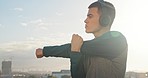 Headphones, man and stretching with music, exercise and in city for health, wellness and fitness. Young male, listen to online audio and relax for workout, training and motivation outdoor for sports.