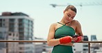 Fitness, phone and woman outdoor for kickboxing exercise, cardio training or workout on a city bridge while on social media for communication to chat. Female fighter using 5g network for urban sport