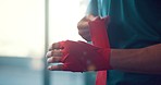 Hands, fighter and bandage wrapping fist for boxing sports, training or exercise in preparation for match. Hand of boxer tying gloves getting ready for fighting competition, practice or gym workout