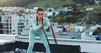 Rope, fitness and woman training on a rooftop for motivation, health and body performance. Workout, exercise and tired girl breathing during cardio with battle ropes, thinking and idea for sports