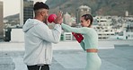 Fitness, couple and boxing in sport training, exercise or workout together in the city outdoors. Active man and woman boxer in sports exercising, cardio or fighting practice on a roof top in a town