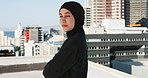 Muslim, woman and fashion with hijab, clothes and religious with a city background. Islam, motivation and Islamic female with arms crossed, pride and strong mindset in New york on a rooftop outdoor 