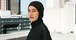 Fitness, city workout and muslim woman in hijab, head scarf and islamic fashion on building rooftop in urban Saudi Arabia. Portrait of arabic woman, runner and athlete motivation, mindset and vision 