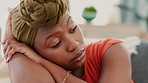 Sad, depression and anxiety of black woman on sofa in living room thinking of student loan, rent or finance with mental health risk, problem or mistake. Depressed, angry and tired woman with job fail