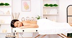 Spa, cupping therapy and woman massage while relax on table for holistic body, muscle and pain care wellness in zen room. Sleeping, calm and healing asian or Japanese girl in glass physical therapy 