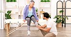 Sports injury, physiotherapy and senior woman, ankle problem from exercise at physiotherapist office for exam. Healthcare, fitness and leg pain, grandma at emergency orthopedic appointment with man.