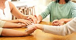 Family hands, faith and Christian prayer group of people or friends with hope, religion and trust or respect. Together, helping and love community with support, solidarity and teamwork at a table