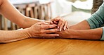 Support, comfort and people holding hands on table for companionship, compassion and care. Family, love and middle aged women hold each other to express trust, empathy and emotional understanding 