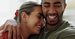 Young couple hugging in home for love, care and romance together in relaxing house. Face of smile, laughing and relax man, woman and people in happy marriage, joyful relationship and sweet happiness 