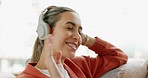 Relax, music and dance with a woman streaming audio from the sofa of a living room in her home alone. Freedom, headphones and lifestyle with a female listening to the radio in her house on a weekend