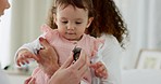 Doctor, baby and mother during pediatrician healthcare, consultation and care with stethoscope to check breathing and heart health. Mother, child and woman doing medical examination in hospital