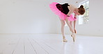 Ballet, dance and dancer studio with a student getting ready for fitness and workout in a studio. Ballerina performance artist, young woman and dancing of a girl tie shoes for training and exercise