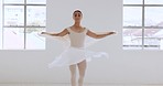 Woman, ballet and dancer or artist twirling around in a creative white art studio indoors. Graceful female ballerina dancing and embracing the arts of dance elegance, performance or skill and talent