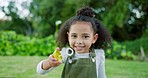 Smile, girl and blowing bubbles outdoor for happiness, joy and have fun. African American child, happy kid and make bubbles being playful, cheerful and carefree childhood, vacation and laughing.