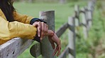 Hands, farm and relax with a woman leaning on a wooden fence outdoor in nature alone with mockup. Spring, agriculture and countryside with a female standing by a wood barrier in a green garden