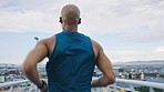 Fitness, city and man running on bridge training in a cardio exercise or workout for a sports marathon. Motivation, wellness and healthy athlete runner in headphones exercising with freedom on a road