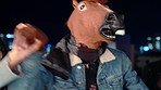 Party, dance and man in horse mask, having fun and celebrating new year. Event, celebration or group of people, friends and women dancing with male in comic costume enjoying holiday together at night