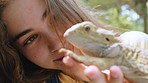 Iguana, girl and wildlife zoo for learning, fun excursion and education in nature. Happy, young and excited teenager holding exotic reptile, lizard and animal in ecosystem, petting zoo and biology 