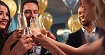 Young diverse friend group holding glasses toasting at party