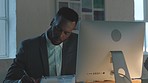 Black man, night and office for writing in book at desk, computer or stress for financial indicators. Businessman, pc and notebook for data, report or notes for idea, goal or strategy on stock market
