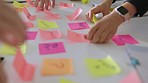 Hands, sticky notes and team brainstorming for marketing strategy and schedule in office. Teamwork, post it and coworkers writing, sales growth and planning for data analysis, ideas and team building