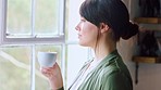 Window, coffee and thinking with a woman in her home to relax while looking at the view in the morning. Peace, idea and tea with a young female drinking a warm beverage in her house alone