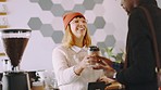 Happy barista and woman at cafe with coffee for customer at counter with cheerful smile. Customer service, coffee shop and professional worker giving takeaway drink to satisfied client.

