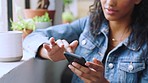 Phone, social media and coffee shop with a black woman drinking coffee by a window to relax during time off. Cafe, customer and thinking with a young female enjoying a caffeine drink in a restaurant