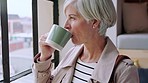 Business woman, drinking coffee or thinking by window in modern office, advertising studio or marketing agency. Manager, mature ceo or leadership with drink, creative ideas or design innovation goals