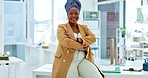 Business leader, black woman and arms crossed on a office desk with a smile and pride for career choice and leadership. African entrepreneur happy with a positive mindset for future success and goal