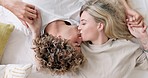 Relax, bed and couple kiss top view for love, care and happiness at home together. Happy, smile and romance of young dating people in bedroom kissing for bond and intimacy in Australia.

