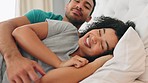 Couple, talking and happy cuddle in the bed to relax and rest while at home to sleep. Bedroom, man and woman or happy couple snuggling with romance in a loving, caring cosy relationship 