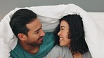 Happy, love and couple with a smile in bed relaxing, bonding and resting together at their home. Happiness, smile and loving young man and woman lying in the bedroom at house or hotel in Puerto Rico.