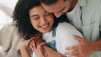 Couple, love and hug in living room for romance, happy relationship or relaxing lifestyle at home. Young man, woman and interracial partners with support, trust and quality time together in apartment