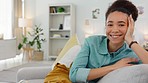 Woman, sofa and face with smile, thinking and happy idea in home, living room or apartment. Black woman, couch and relax in lounge, house and daydream with vision, goal or happiness in Los Angeles