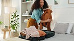 Black woman, suitcase and packing for travel in bedroom in home or vacation apartment. Luggage, clothes and happy african woman ready for holiday trip, solo adventure or traveling journey to Africa